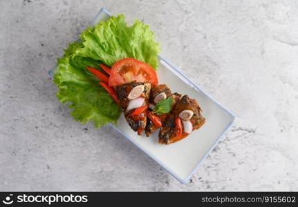 Selective focus appetizers with spicy sardine mixed with herb in white tray, copy space