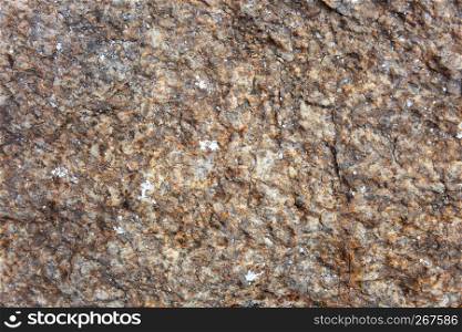 Selective focus at the center of old brown granite rustic and rough stone with texture detail, Close-up, Abstract nature grungy background.