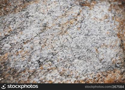 Selective focus at the center of rock surface textured with blurry and vignette border, Abstract grunge nature background.
