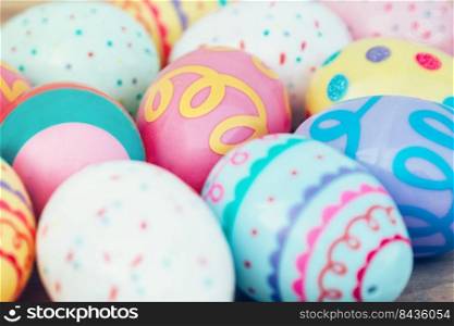 Selective focus colorful easter egg on wood table background.