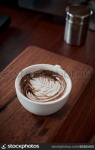 Selective focus cup of hot latte art coffee,focus at white foam . hot latte art coffee