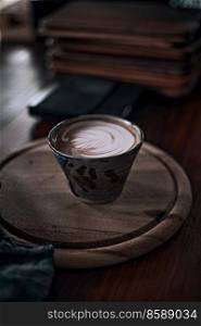 Selective focus cup of hot latte art coffee on wooden table,focus at white foam . cup of hot latte art coffee 