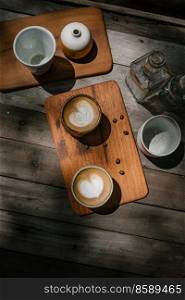 Selective focus cup of hot latte art coffee on wooden table,focus at white foam . cup of hot latte art coffee
