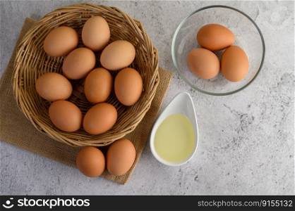 Selective focus eggs on sack cloth, many eggs on wicker basket and glasses bowl, the egg whisk placed on the floor, preparing for cooking food or dessert, copy space