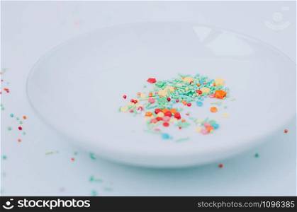 Selective focus Festive abstract multicolored candy sprinkles. Yellow red green orange blue circles, doodles, flowers, neon blurred. Easter, birthday greeting card or web banner concept. Blurred