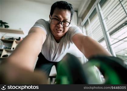 Selective focus, Funny overweight man wearing eyeglasses is workout with ABS hand-roller for healthy, copy space