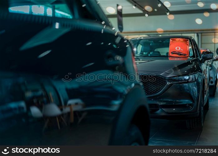 Selective focus luxury SUV car parked in luxury showroom. Car dealership office. New car parked in modern showroom. Car for sale and rent business concept. Automobile leasing and insurance background.