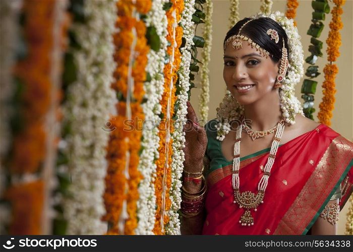 Selective focus of bride standing by garlands