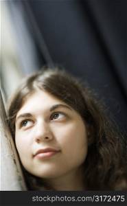 Selective focus of Caucasian young adult woman looking up.