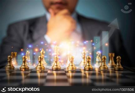 Selective focus of golden chess and success business graph in front of professional business analysis man. Concept of leadership must-have solution for the financial crisis