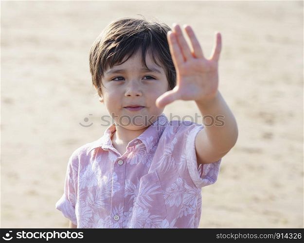 Selective focus of little boy showing five fingers, Portrait kid primary school counting number five, Child showing five numbers with fingers, Education or Toddler development concept