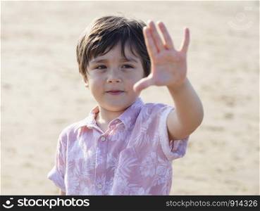 Selective focus of little boy showing five fingers, Portrait kid primary school counting number five, Child showing five numbers with fingers, Education or Toddler development concept