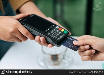 Selective focus on Credit card in hand of Young woman paying with credit card, smart payment, contactless payment concept