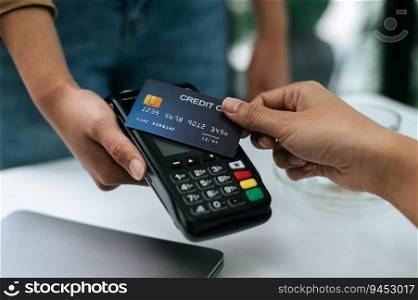 Selective focus on Credit card in hand of Young woman paying with credit card, smart payment, contactless payment concept