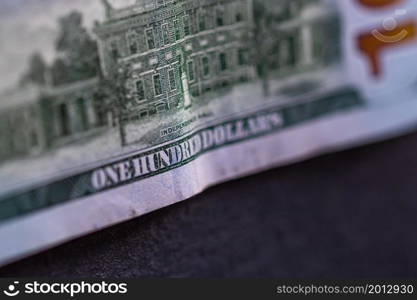 Selective focus on detail of 100 dollars banknote. Close up macro detail of money banknotes, dollars isolated. World money concept, inflation and economy concept