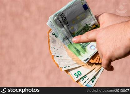 Selective focus on detail of EURO banknotes. Counting or giving EURO banknotes. World money concept, inflation and economy concept