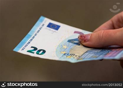 Selective focus on detail of EURO banknotes. Counting or giving EURO banknotes. World money concept, inflation and economy concept