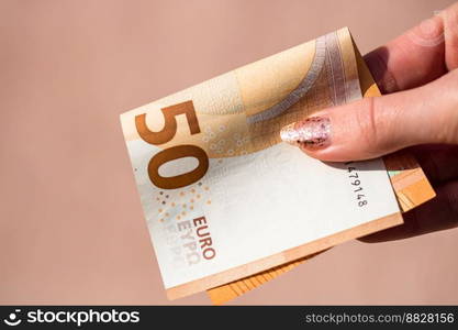 Selective focus on detail of EURO banknotes. Counting or giving EURO banknotes. World money concept, inflation and economy concept