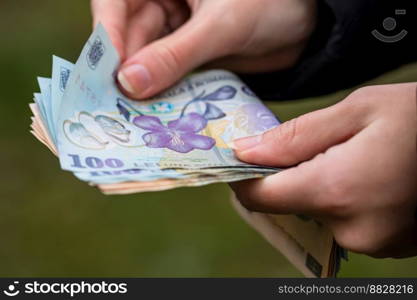 Selective focus on detail of LEI banknotes. Counting or giving Romanian LEI banknotes. World money concept, inflation and economy concept