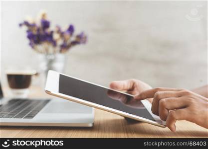 selective focus on hand use digital tablet on work desk