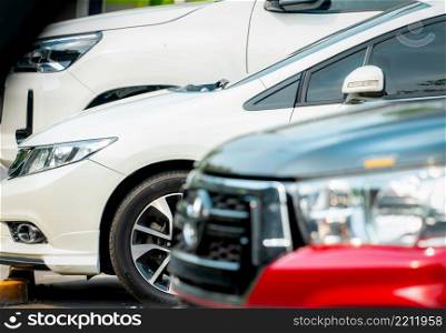 Selective focus on side view of white car parked at outdoor car parking lot. Used car for sale and rental service business. Automobile parking space. Car dealership concept. Auto leasing and insurance
