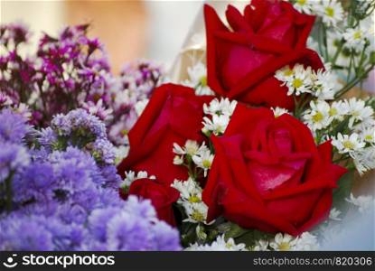 Selective focus red roses bouquet for recent graduates on graduation day.