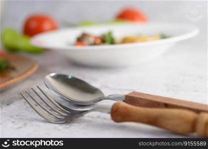 Selective focus spoon with fork , blurred sardine in tomato sauce and spicy sardine on white table, copy space