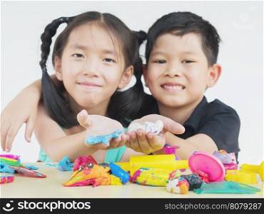 Selective focused of Asian kid playing colorful clay toy