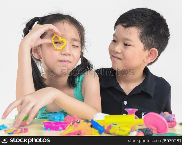 Selective focused of happy Asian kids playing colorful clay toy