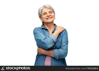 self-care, retirement and old people concept - portrait of smiling senior woman in denim shirt over white background. portrait of smiling senior woman in denim shirt