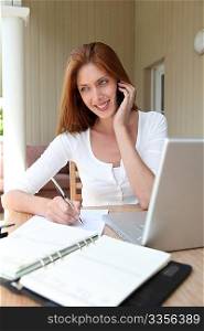 Self-employed woman at home talking on the phone