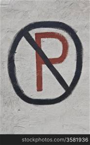 self painted no parking sign on gray wall