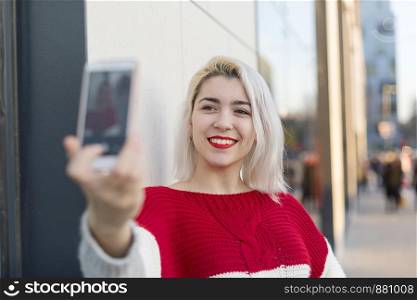 Self portrait of beautiful young blonde woman posing