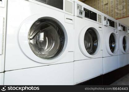 self-service laundry facilities concept - washing machines at laundromat. washing machines at laundromat