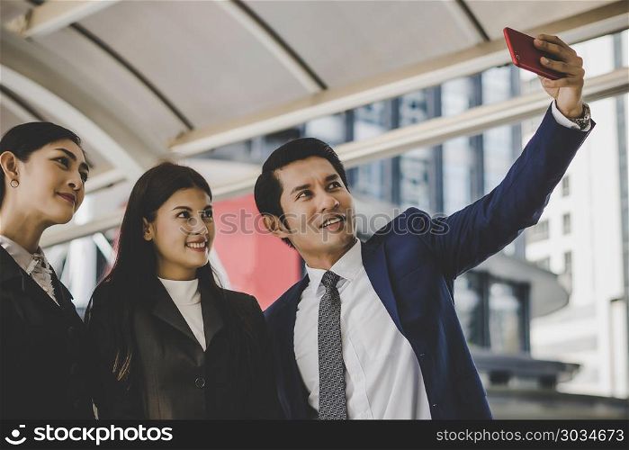 Selfie business partners on smartphone.