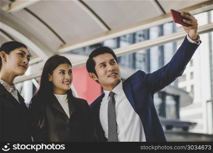 Selfie business partners on smartphone.