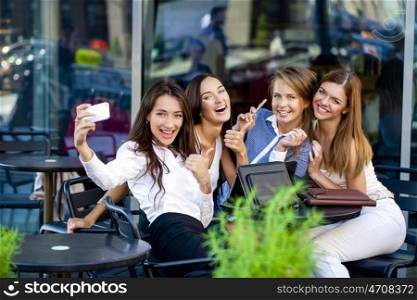 Selfie Five women sitting in a cafe on the street