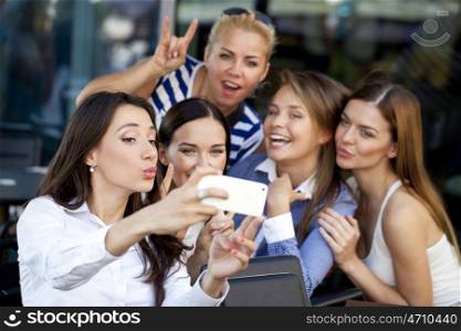 Selfie Five women sitting in a cafe on the street