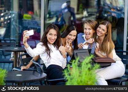 Selfie Five women sitting in a cafe on the street