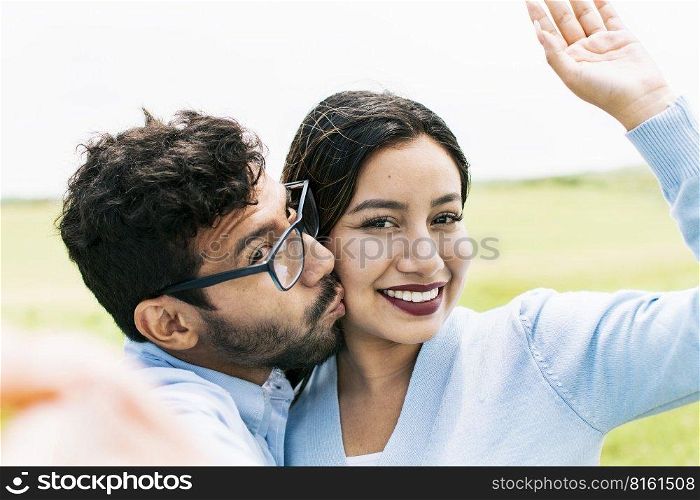 Selfie of a young couple kissing, Lifestyle of a cute couple taking a selfie, couple in love taking a selfie, concept of couples in love selfies