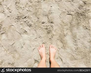 Selfie of barefoot on beach sand background, top view&#xA;