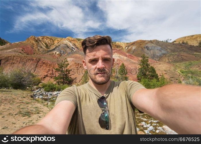Selfie of man in Valley of Mars landscapes in the Altai Mountains, Kyzyl Chin, Siberia, Russia. Valley of Mars landscapes