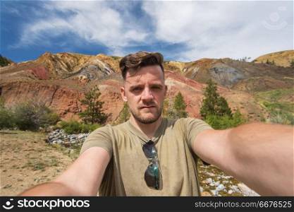 Selfie of man in Valley of Mars landscapes in the Altai Mountains, Kyzyl Chin, Siberia, Russia. Valley of Mars landscapes