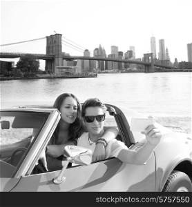 selfie of young teen couple at convertible car in New York Brooklyn Bridge photo mount