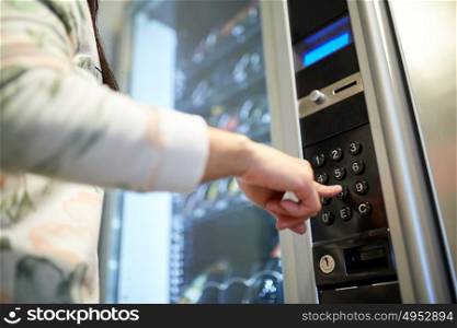 sell, technology and consumption concept - hand pushing button on vending machine operation panel keyboard. hand pushing button on vending machine keyboard