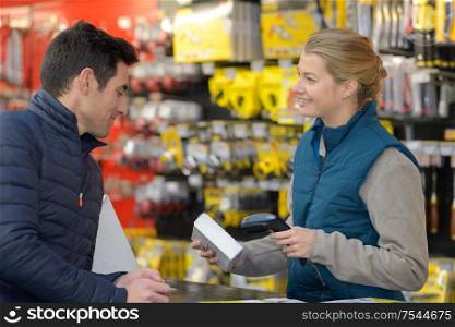 seller with barcode scanner in shop