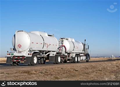 "Semi-truck and trailer combination known as a "double bottom" hauling crude oil."