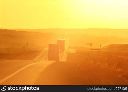 Semi trucks and sun glare along Trans Canada Highway