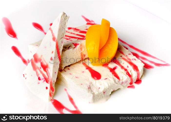 Semifreddo, Italian style ice cream with candied fruits, apricot and sweet sauce