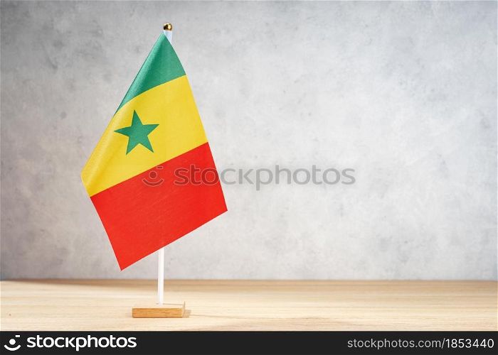 Senegal table flag on white textured wall. Copy space for text, designs or drawings